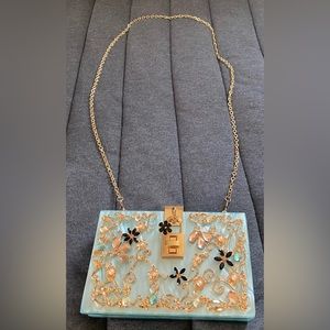 Acrylic clutch w rhinestone/crystal accents.